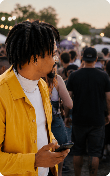 A person using Cue at an outdoor crowd event