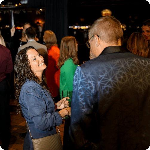 People talking at an evening event